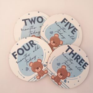 baby milestone discs with brown bear on blue background